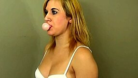 Bubble gum bubbles in a piece of lacy white lingerie