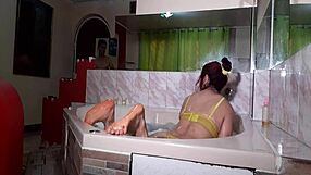 A beautiful MILF sits on a slide of donkey castle while her friend washes her anus