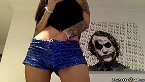 Tattooed brunette reveals her tight pussy in emotional webcam show