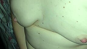 The wife experiences a double orgasm while playing with her boobs in the bedroom.