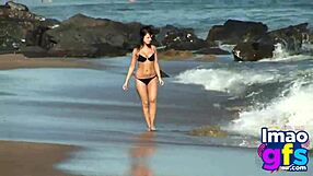 Hot brunette babe in lingerie masturbates pussy on beach, reaching orgasm with lesbian sucking