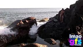 Hot brunette babe in lingerie masturbates pussy on beach, reaching orgasm with lesbian sucking