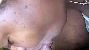 Side view of ebony teen with big tits and tattoo sucking monster cock at work, leading to cumshot.