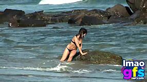 Hot brunette babe in lingerie masturbates pussy on beach, reaching orgasm with lesbian sucking