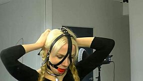 Bound in bondage, the submissive wears a ball gag harness, part 01 of the BDSM session.