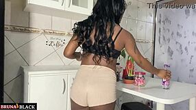 Pregnant housewife in kitchen sheer