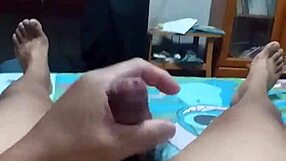 lying on bed, stroking cock with intense pleasure until spraying cum