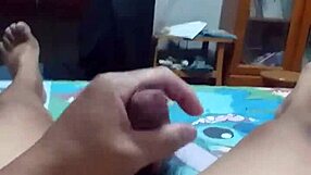 lying on bed, stroking cock with intense pleasure until spraying cum