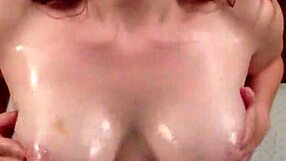 Redhead teases with oiled tits and jerk off instructions