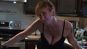 Cute redhead dances in kitchen