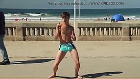 Twink dancing on beach with tight speedo bulge showing off.