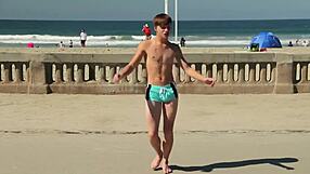 Twink dancing on beach with tight speedo bulge showing off.