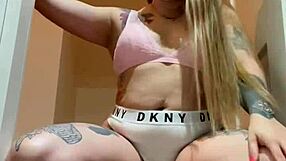 In a steamy video, a blonde teen with small tits and tattoos greet the viewers