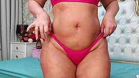 i watch a pretty redhead perform a sensual dance in pink lingerie