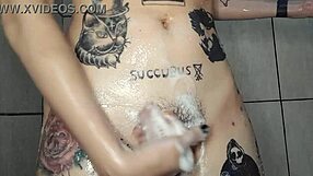 Skinny naked girl with tattoos and piercings bathes her big tits and ass