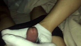 Footjob and sperm on a beautiful girl in white socks.