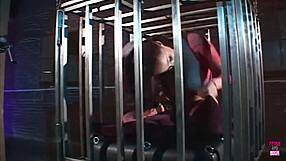 Brunette SLAVE in cage DEEPTHROATS and SUCKS cock for freedom, titty fucks, and earns cum facial.