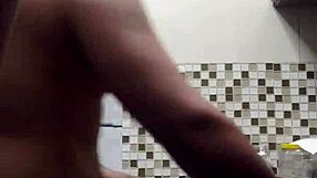 macho guy bent over washing dishes, with a suggestive twist