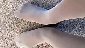 Wearing white nylons, I play with a banana in a rather kinky manner