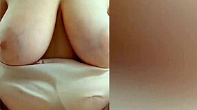 Teen in pink dress plays with her big tits