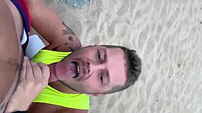 Public gay beach scene with a steamy blowjob
