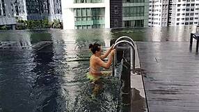 sexy brunette stands up to piss hot pee on legs in clubhouse shower close-up