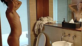 sexy brunette stands up to piss hot pee on legs in clubhouse shower close-up