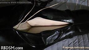 Bound in tight bondage, the submissive endures sadomasochistic pleasures with ropes and restraints