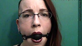 Redhead gets dirty with ball gag and lipstick