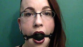Redhead gets dirty with ball gag and lipstick