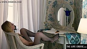 I'm a horny blonde in fishnets, riding my huge black dildo doggy style.