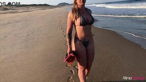 Young woman enjoys sex on the beach with a fan
