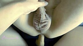 A petite woman dominates her best friend with a strap on in a hot scene