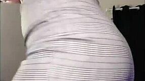 Curvy redhead dances sexily in fishnets and lingerie