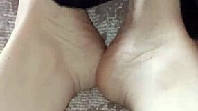 Gretala suggestively rubs her thong on her bare feet.