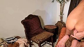 She mounts and rides the massive dildo with intense passion.