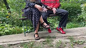 hot milf jerks off big dick into glass in park on bench