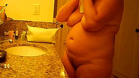 The hidden camera captures a mature woman's private moments in detail