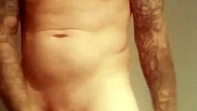 He pulls out his massive tattooed cock for a solo homemade masturbation session.