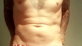 He pulls out his massive tattooed cock for a solo homemade masturbation session.