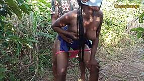 Black ebony village slay queen gets fucked doggystyle in the bush with hairy pussy spread wide. Tits bounce as he pounds her hard outdoors.