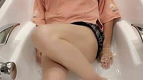 Shemale ting xuan takes a bath in the bathtub wearing clothes
