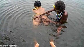 Two Skinny Black Lesbian Tribe Members Bath Together Outdoors in Village River with Big Tits Kissing