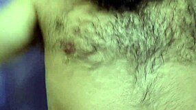 hairy bodybuilder shows off muscular arms and long hair in outdoor striptease with clothes ripped for 10 uncut minutes.