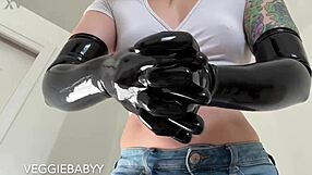 she teases her pet in the cage with long black latex gloves and femdom flair, full video on veggiebabyy manyvids