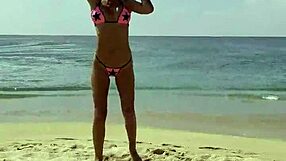 Monika Fox poses solo in pink bikini with stars on the beach showing big fake tits free