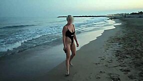 blonde shows tits and sucks cock on a public beach with brunette watching