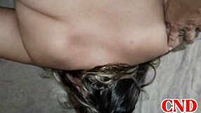 In the dorm, the Brazilian girlfriend bends over on the bed as the husband watches her scream during intense action