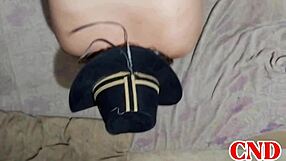 In the dorm, the Brazilian girlfriend bends over on the bed as the husband watches her scream during intense action