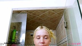 Elegant shy blonde steps into steamy shower gracefully